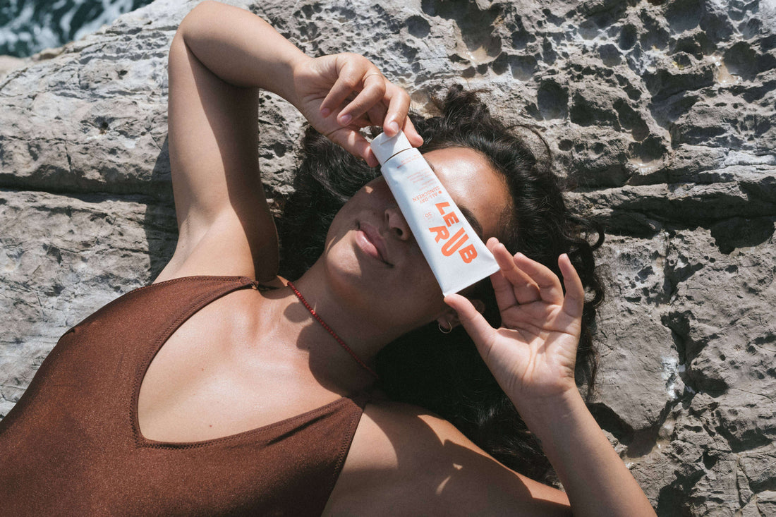 Girl Holding All Day Sunscreen on Face